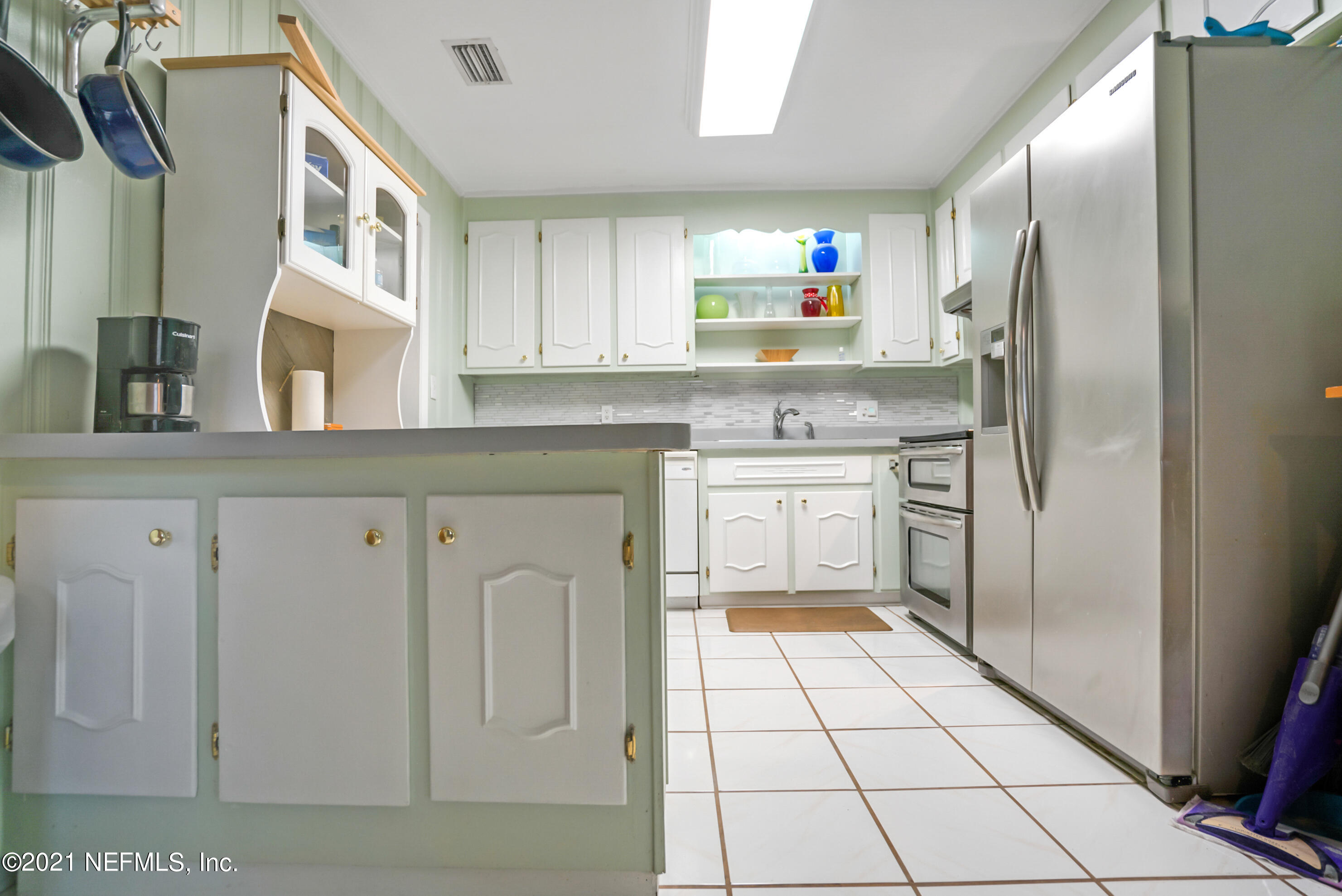 4004 Rogero Road Jacksonville, FL 32277 - Photo 6 of 19 a kitchen with stainless steel appliances a refrigerator sink and cabinets