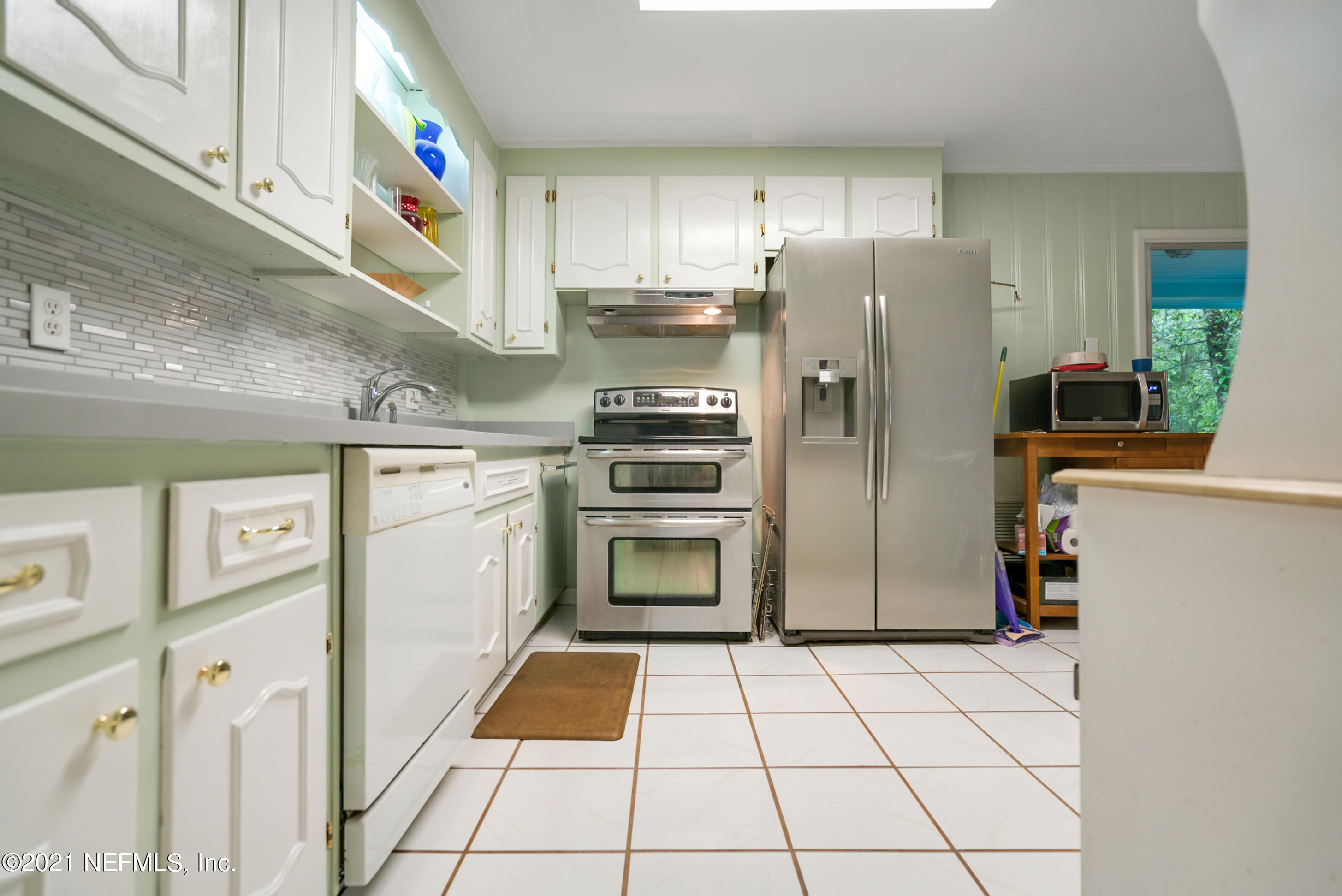 4004 Rogero Road Jacksonville, FL 32277 - Photo 7 of 19 a kitchen with granite countertop a refrigerator and a stove