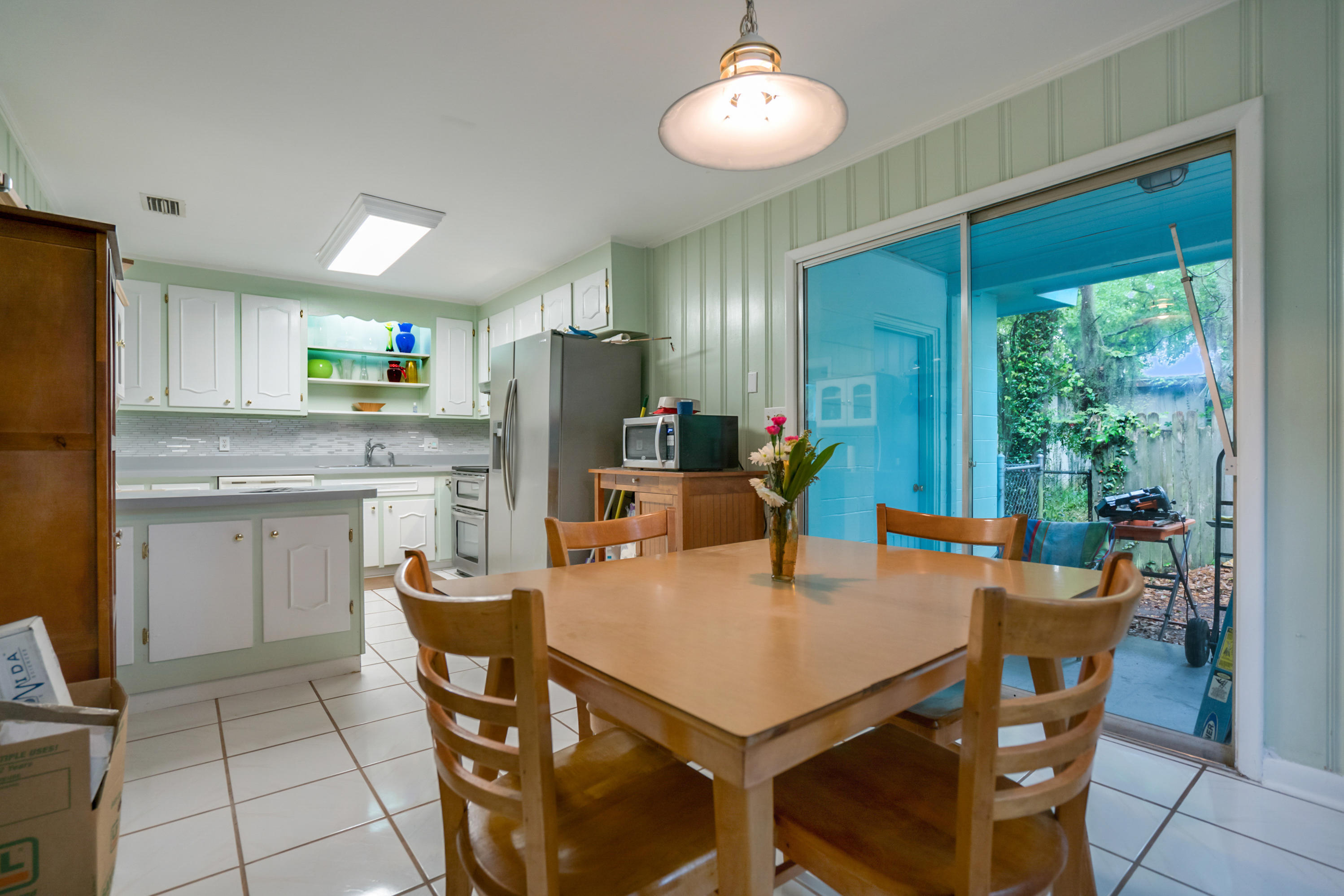 4004 Rogero Road Jacksonville, FL 32277 - Photo 9 of 19 a view of a dining room with furniture and a chandelier