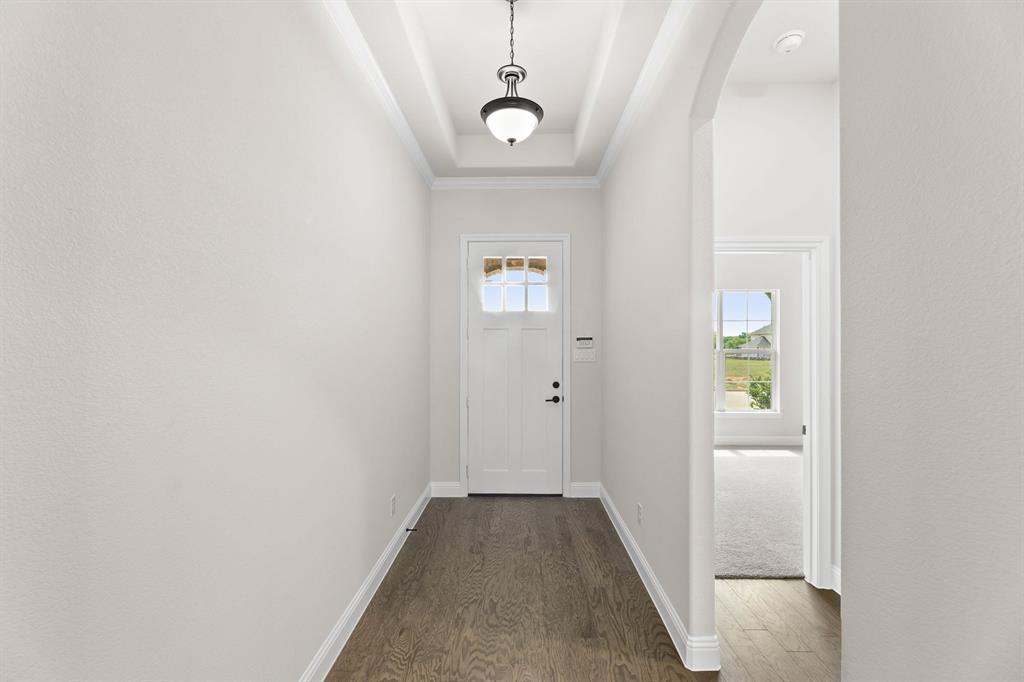 35 Magpie Street Joshua, TX 76058 - Photo 12 of 19 a view of a hallway with wooden floor and glass door