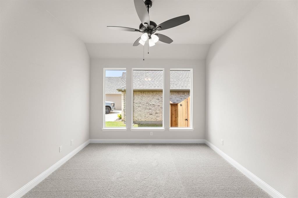 35 Magpie Street Joshua, TX 76058 - Photo 13 of 19 an empty room with a window and a ceiling fan