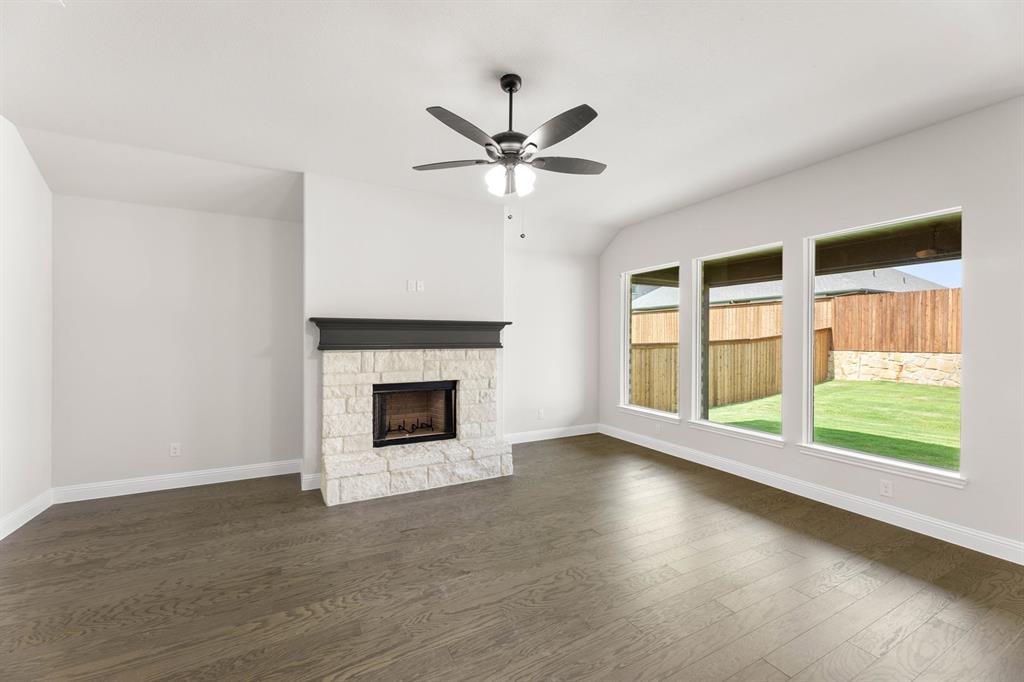 35 Magpie Street Joshua, TX 76058 - Photo 4 of 19 a view of an empty room with a fireplace and a window
