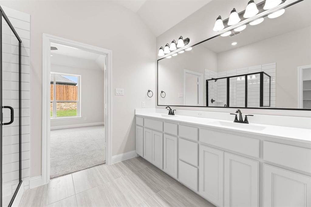 35 Magpie Street Joshua, TX 76058 - Photo 9 of 19 a bathroom with a double vanity sink and a mirror