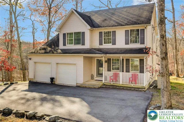 a view of a house with a yard covered in snow