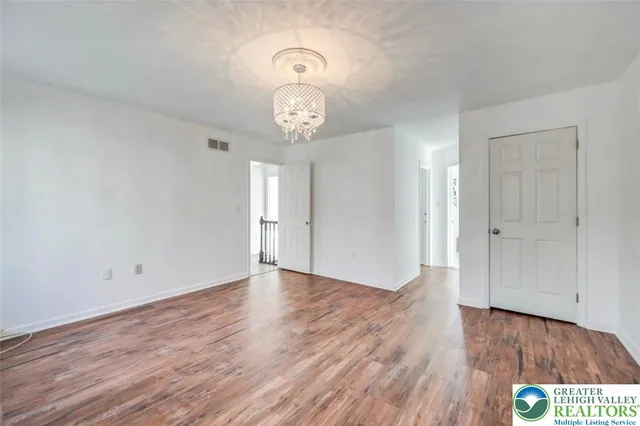 a bathroom with a granite countertop sink a toilet and a mirror
