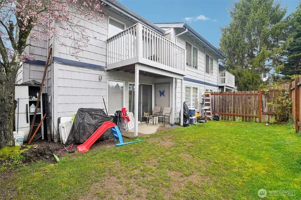 a view of a house with a backyard and porch