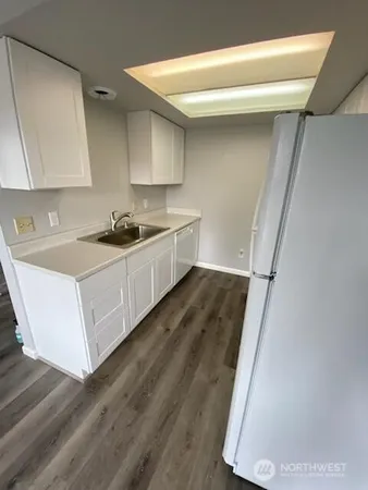 a kitchen with a sink a stove and cabinets