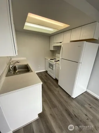 a utility room with sink dryer and washer