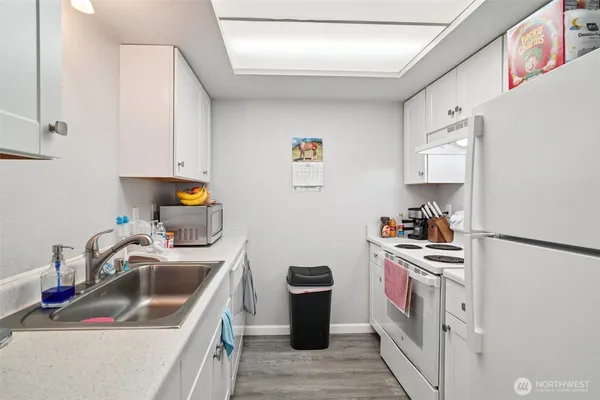 a kitchen with a sink stove and refrigerator