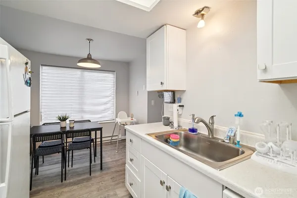 a room with a table chairs and a window