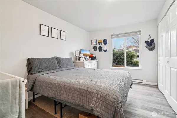 a bedroom with a bed and a large window