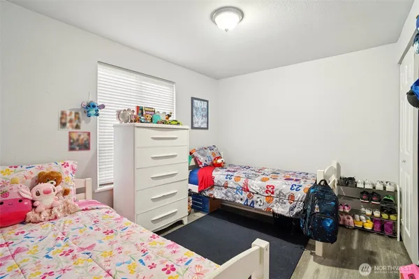 a bedroom with a bed and a dresser in it