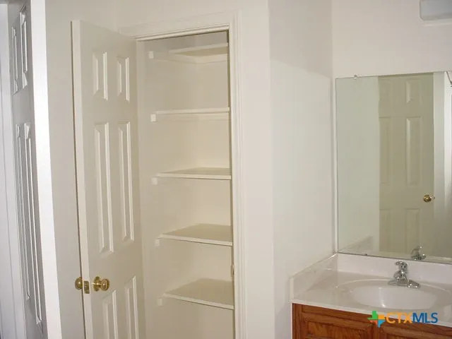 a bathroom with a shower and a sink