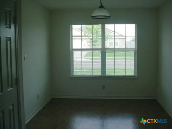 a view of hallway with wooden floor