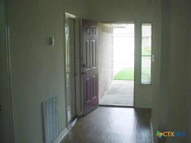 a bathroom with a shower curtain and a toilet