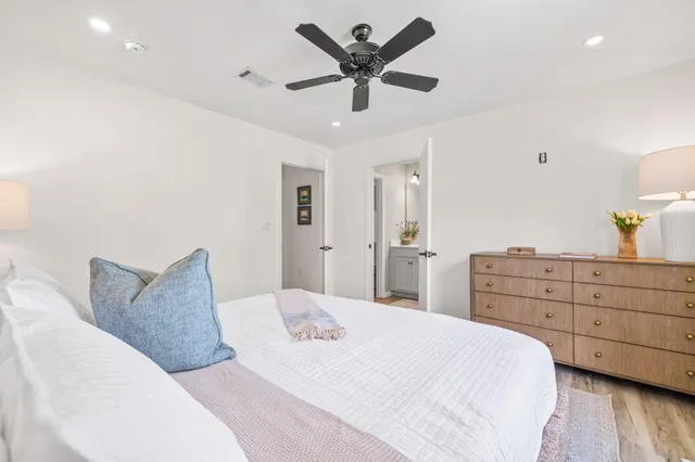 a bedroom with a bed and ceiling fan