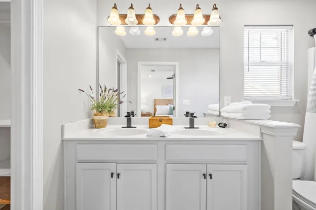 a bathroom with a sink double vanity and a mirror