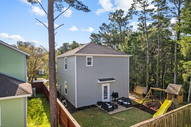a view of a backyard with chairs and a fire pit