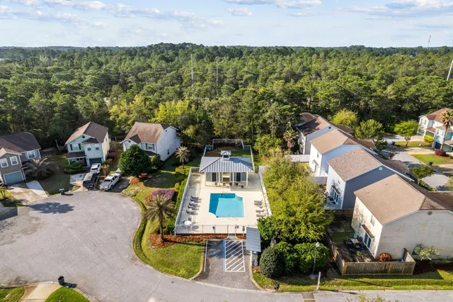 an aerial view of a house with a garden and lake view