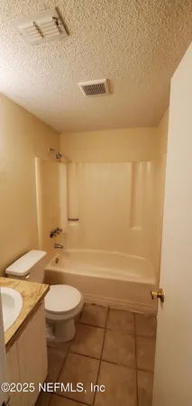 a bathroom with a toilet a sink and bathtub