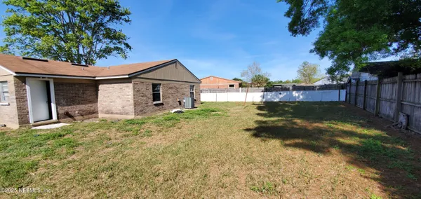 a backyard of a house with lots of green space
