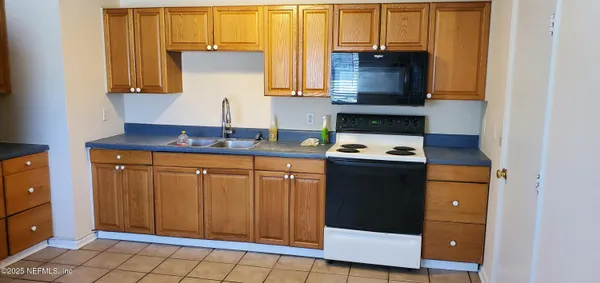 a kitchen with stainless steel appliances a stove a microwave and a refrigerator