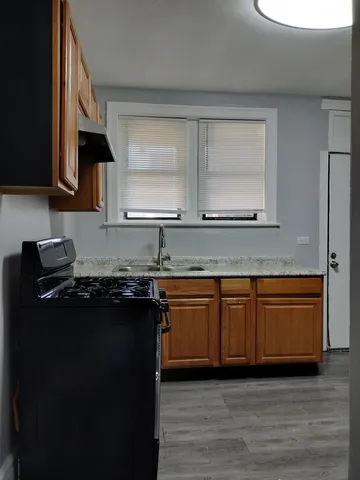 a kitchen with stainless steel appliances granite countertop a stove a sink and a microwave