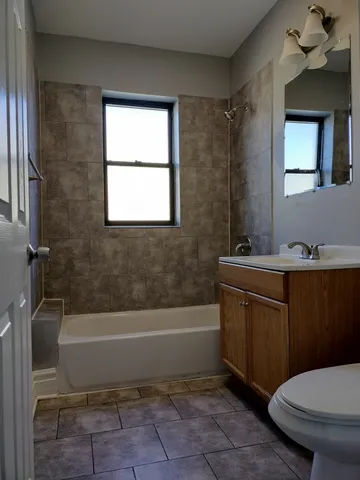 a bathroom with a sink a toilet and bathtub