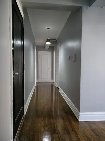 a view of hallway with wooden floor