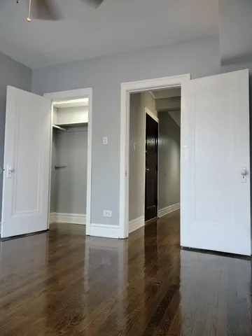 an empty room with wooden floor and closet