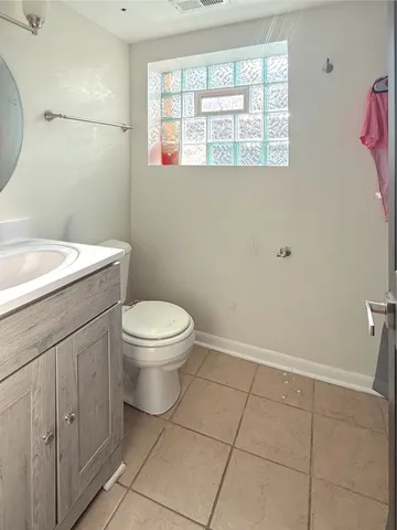a bathroom with a toilet sink and window