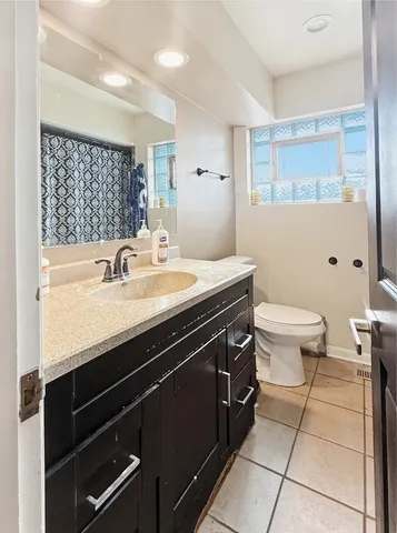 a bathroom with a sink a toilet a mirror and shower