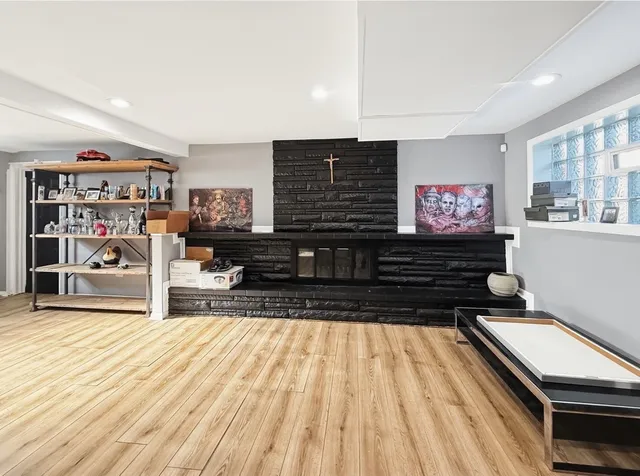 a living room with stainless steel appliances kitchen island granite countertop a stove and a cabinets