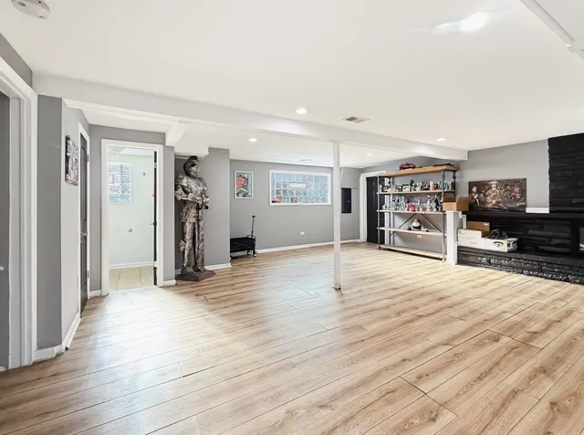 an empty room with wooden floor and furniture