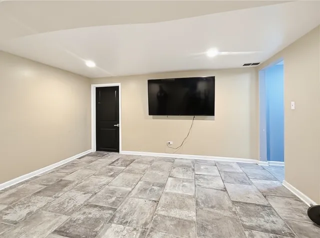 a view of an empty room with a flat screen tv