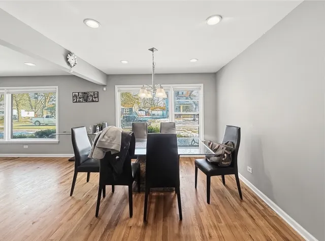 a dining room with furniture and wooden floor