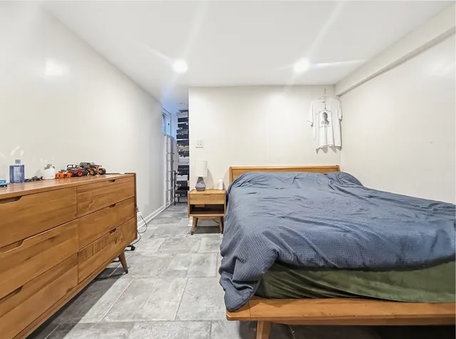 a bedroom with a bed and a window