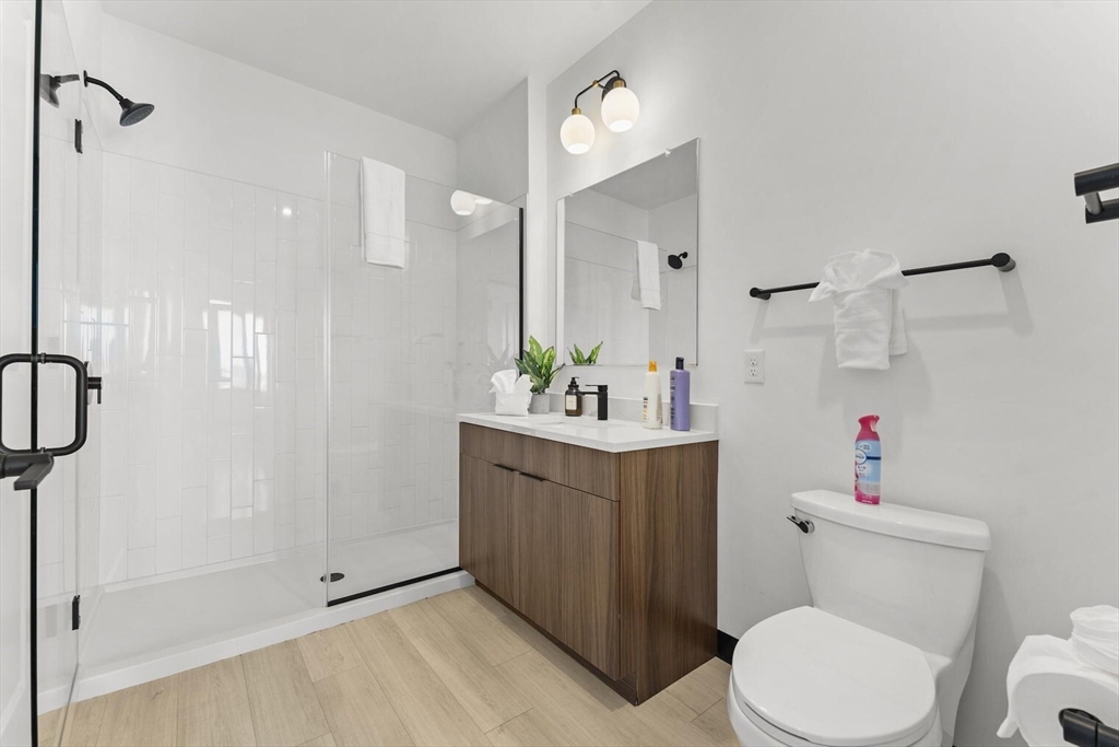 600 Broadway, Unit 513 Chelsea, MA 02150 - Photo 12 of 31 a bathroom with a sink a toilet and shower