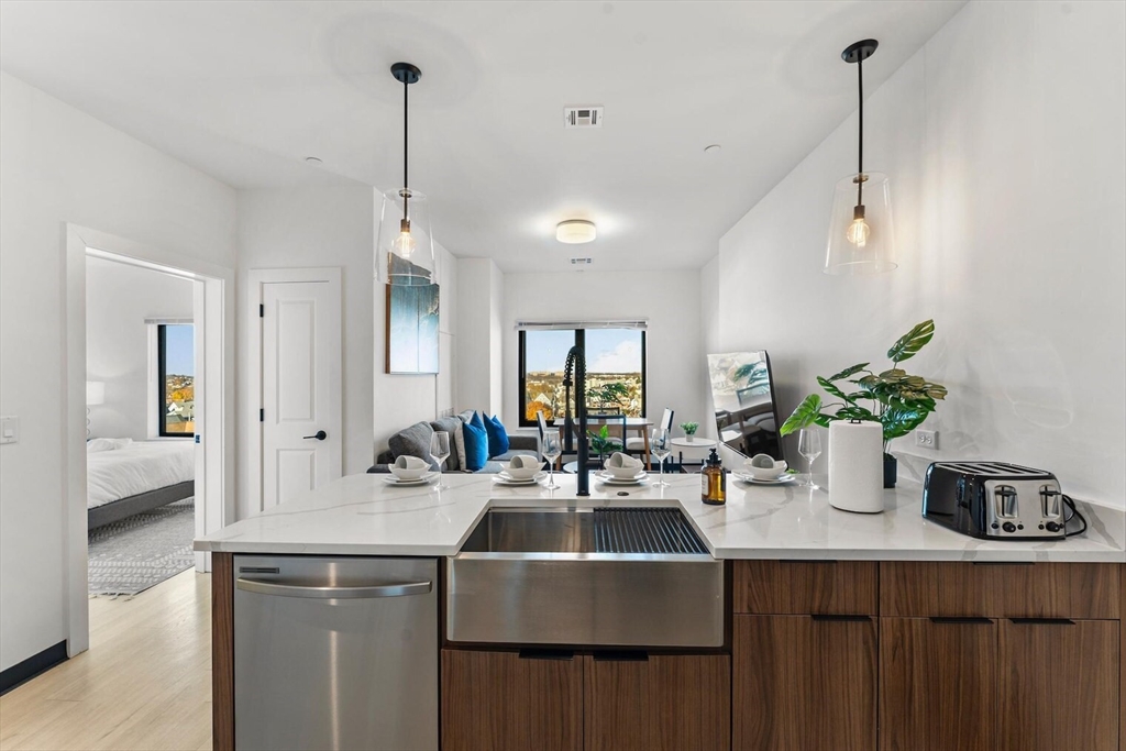 600 Broadway, Unit 513 Chelsea, MA 02150 - Photo 5 of 31 a kitchen with sink and refrigerator