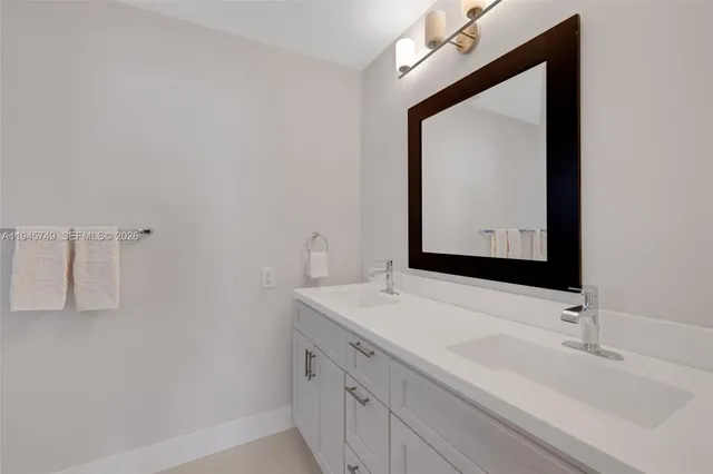 a bathroom with a sink vanity and a mirror