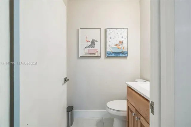 a white toilet sitting next to a bathroom sink