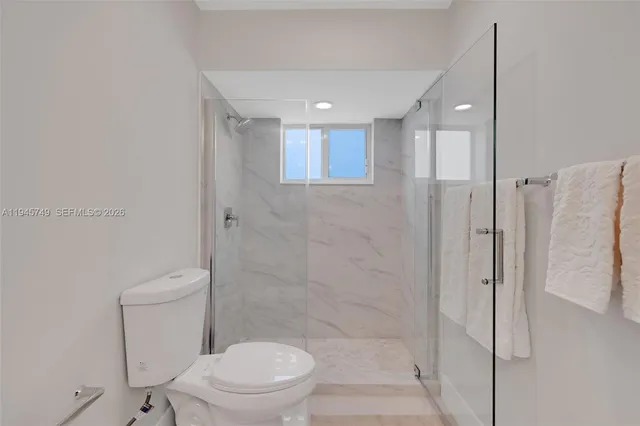 a bathroom with a toilet and a shower
