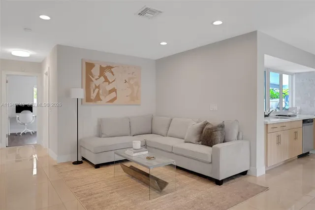 a living room with furniture and painting on the wall