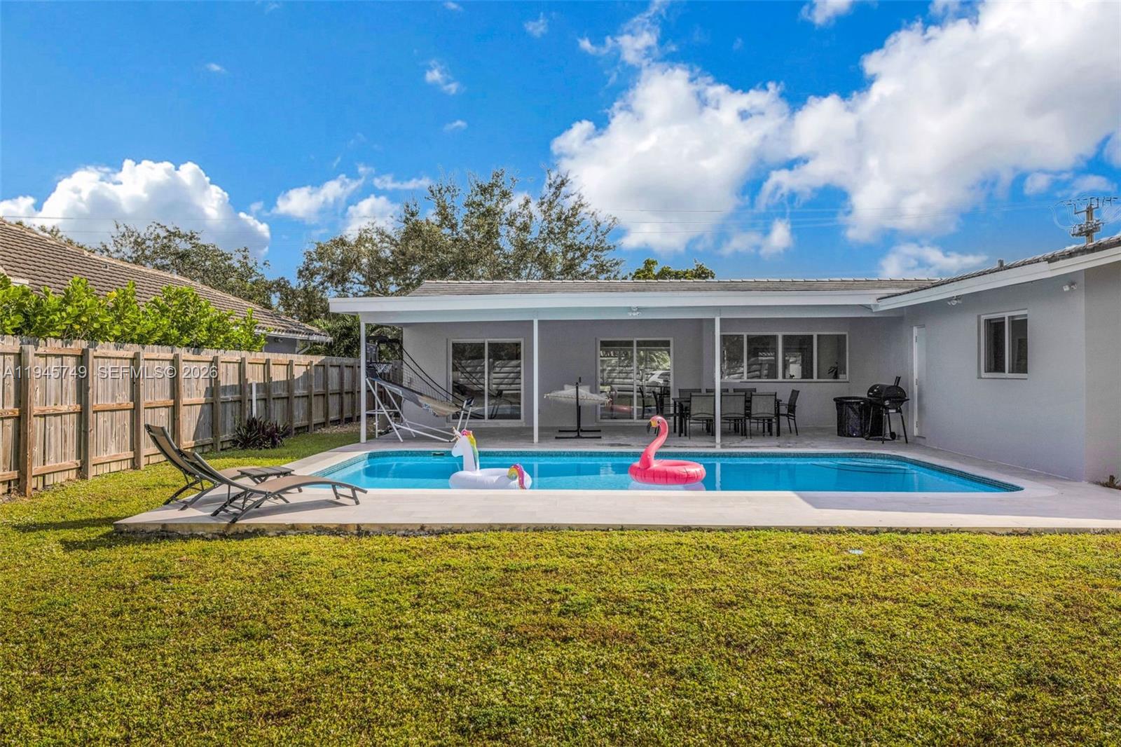 3500 North Park Road Hollywood, FL 33021 - Photo 37 of 39 a view of pool with lawn chairs and large trees