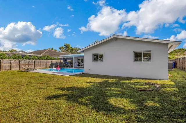 a house view with swimming pool and garden