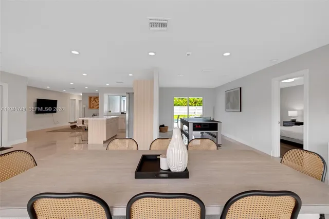 a living room with furniture a couch and a flat screen tv