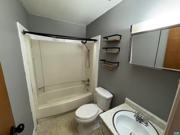 a bathroom with a toilet and a tub