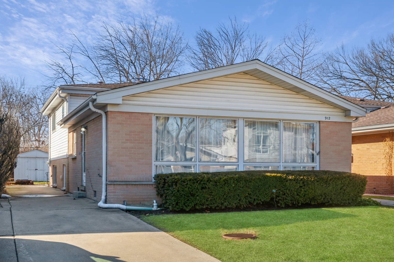 912 Long Road Glenview, IL 60025 - Photo 1 of 1 a front view of a house with a garden and plants