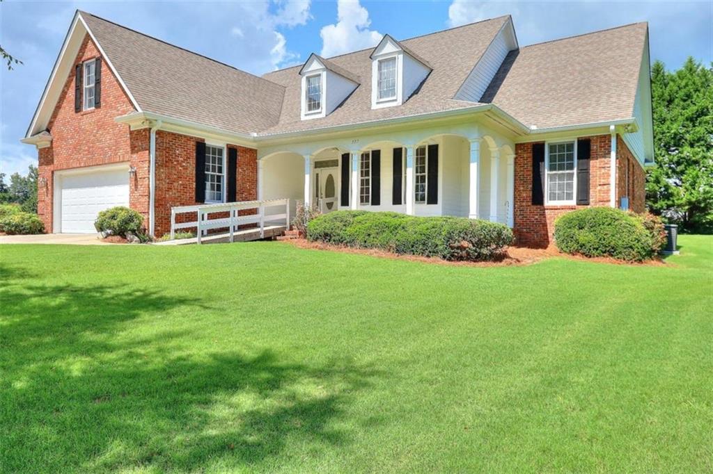 557 Arrowhead Circle Rutledge, GA 30663 - Photo 1 of 1 a front view of a house with a yard and porch