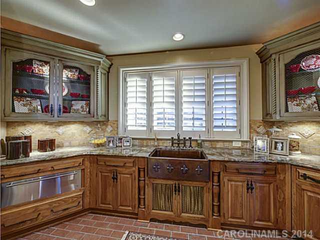 16505 Jetton Road Cornelius, NC 28031 - Photo 11 of 23 a kitchen with stainless steel appliances granite countertop a sink and a granite counter tops with wooden cabinets
